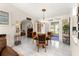 Dining room with a round table, light fixture and decor, adjacent to the kitchen at 9645 Se 173Rd Pl, Summerfield, FL 34491