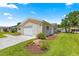 Charming single-story home with a well-manicured lawn, long driveway, and attached garage at 9645 Se 173Rd Pl, Summerfield, FL 34491