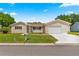 Lovely home featuring a green lawn, trimmed landscaping, and a well-maintained driveway at 9645 Se 173Rd Pl, Summerfield, FL 34491