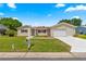 Nice home with green lawn, neatly trimmed shrubbery, and a well-maintained driveway and curb appeal at 9645 Se 173Rd Pl, Summerfield, FL 34491