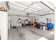 Spacious two car garage with ample storage space and a workbench at 9645 Se 173Rd Pl, Summerfield, FL 34491