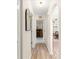 Inviting hallway with wood-look flooring leading to various rooms at 9645 Se 173Rd Pl, Summerfield, FL 34491