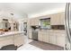 Bright kitchen with stainless steel appliances, light cabinets, and tile backsplash at 9645 Se 173Rd Pl, Summerfield, FL 34491