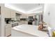 Kitchen with stainless steel appliances and light wood cabinets, with an island at 9645 Se 173Rd Pl, Summerfield, FL 34491
