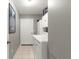 Efficient laundry room with updated washer, dryer, and ample storage cabinetry at 9645 Se 173Rd Pl, Summerfield, FL 34491
