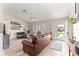 Spacious living room with wood floors, ceiling fan, and ample natural light at 9645 Se 173Rd Pl, Summerfield, FL 34491