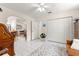 Bright living room featuring tile floors, a ceiling fan, and an open archway to the kitchen and other spaces at 9645 Se 173Rd Pl, Summerfield, FL 34491