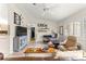Inviting living room featuring hardwood flooring, ceiling fan, and comfortable seating at 9645 Se 173Rd Pl, Summerfield, FL 34491