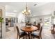 Open floor plan with dining area, kitchen, and living room with natural light at 9645 Se 173Rd Pl, Summerfield, FL 34491