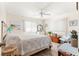Bright primary bedroom with ceiling fan, wood flooring and serene decor at 9645 Se 173Rd Pl, Summerfield, FL 34491