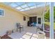 Covered patio with seating area, perfect for outdoor dining and entertaining with a view of the backyard at 9645 Se 173Rd Pl, Summerfield, FL 34491