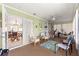 Relaxing sunroom with cozy seating, bright green walls, and lots of natural light and peaceful charm at 9645 Se 173Rd Pl, Summerfield, FL 34491