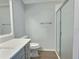 Bathroom featuring modern vanity with white countertop and a glass-enclosed shower at 997 Oscar Ln, The Villages, FL 32162