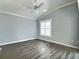 Clean bedroom with neutral paint, waterproof floors, white trim, and a window with shutters at 997 Oscar Ln, The Villages, FL 32162