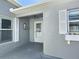 Home entryway featuring a white front door, neutral paint color, and decorative shutters on the windows at 997 Oscar Ln, The Villages, FL 32162