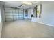 Spacious two car garage with epoxy flooring and ample storage space at 997 Oscar Ln, The Villages, FL 32162