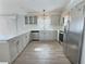 Bright kitchen with stainless steel appliances, quartz countertops, and modern cabinetry at 997 Oscar Ln, The Villages, FL 32162