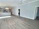 Open-concept living space with waterproof floors, recessed lighting, and access to the kitchen and bedrooms at 997 Oscar Ln, The Villages, FL 32162