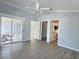 Large main bedroom with waterproof floors, a ceiling fan, and access to the lanai, bathroom, and closet at 997 Oscar Ln, The Villages, FL 32162