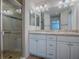 Bright bathroom with double vanity, glass-enclosed shower, and updated fixtures at 1346 Kilgore Way, The Villages, FL 32163