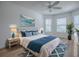 Bright bedroom with ocean-themed decor, large windows, and stylish furnishings at 1346 Kilgore Way, The Villages, FL 32163