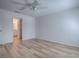 Spacious empty bedroom with light gray walls, ceiling fan, and wood-look floors at 1346 Kilgore Way, The Villages, FL 32163