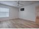 Bright bedroom features laminate flooring, a ceiling fan, and a wall-mounted television at 1346 Kilgore Way, The Villages, FL 32163