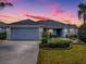 Charming single-story home featuring a well-manicured lawn and a two-car garage, perfect for suburban living at 1346 Kilgore Way, The Villages, FL 32163