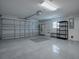 Spacious garage with epoxy floor, shelves, and storage cabinet at 1346 Kilgore Way, The Villages, FL 32163