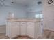 Bright kitchen island with cabinets, outlets, and beige countertop offers extra workspace at 1346 Kilgore Way, The Villages, FL 32163