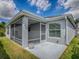 Rear view of the home featuring screened in lanai at 1346 Kilgore Way, The Villages, FL 32163
