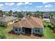 Aerial view of home and neighborhood with well-maintained landscaping and mature trees at 10021 Lake Miona Way, Oxford, FL 34484