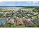 Community aerial view showcasing a quiet neighborhood near a scenic lake and lush landscaping at 10021 Lake Miona Way, Oxford, FL 34484
