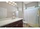 Traditional bathroom with a single sink vanity, large mirror and shower-tub combo at 10021 Lake Miona Way, Oxford, FL 34484