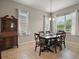 Bright dining room featuring tile floors, large windows, and wooden dining furniture at 10021 Lake Miona Way, Oxford, FL 34484