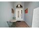 Inviting entryway featuring a mosaic table and charming decor at 10021 Lake Miona Way, Oxford, FL 34484