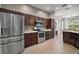 Spacious kitchen featuring stainless steel appliances and dark wood cabinetry at 10021 Lake Miona Way, Oxford, FL 34484
