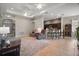 Open living area with ceiling fans and a view of the kitchen and dining space at 10021 Lake Miona Way, Oxford, FL 34484