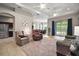 Open living room featuring neutral tones, ceiling fans, and sliding glass doors to outdoor space at 10021 Lake Miona Way, Oxford, FL 34484
