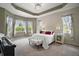 Spacious main bedroom with tray ceiling, bay windows, and ample natural light at 10021 Lake Miona Way, Oxford, FL 34484