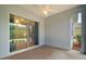 Enclosed patio with ceiling fan features large sliding glass doors and neutral carpeting at 10021 Lake Miona Way, Oxford, FL 34484