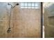 Walk-in shower with tile surround and glass door at 10021 Lake Miona Way, Oxford, FL 34484