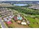 Aerial view of the community with a pool, playground, and lake in the background at 1047 Timbervale Trl, Clermont, FL 34715