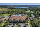 Aerial view of the community pool, clubhouse, and lush landscaping at 1047 Timbervale Trl, Clermont, FL 34715
