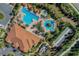 Aerial view of the community's pools, cabanas, shuffleboard court, and clubhouse at 1047 Timbervale Trl, Clermont, FL 34715