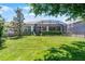 The fenced backyard features a well-manicured lawn and a screened patio at 1047 Timbervale Trl, Clermont, FL 34715
