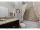 Bathroom with granite countertop, tile surround shower, and tiled floors at 1047 Timbervale Trl, Clermont, FL 34715