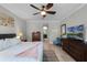 Inviting bedroom with furnishings, ceiling fan, and doorway to bathroom at 1047 Timbervale Trl, Clermont, FL 34715