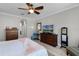 Relaxing bedroom boasts a ceiling fan, wood floors, and doorways to other rooms at 1047 Timbervale Trl, Clermont, FL 34715