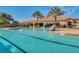 The community pool is surrounded by palm trees and lounge chairs at 1047 Timbervale Trl, Clermont, FL 34715